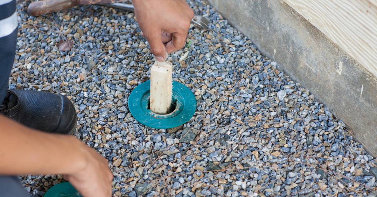 Man replacing termite bait