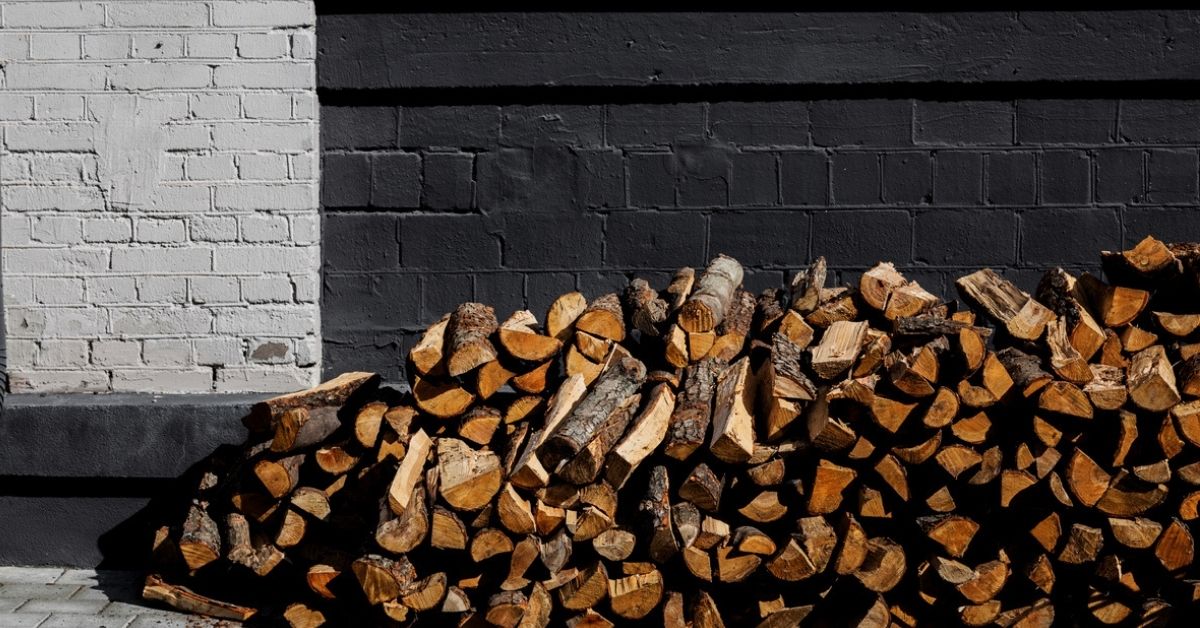 firewood next to home's foundation